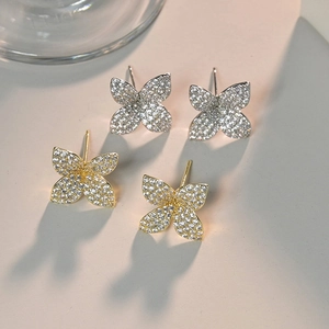 Micro shot of butterfly stud earrings in gold and silver with shimmering AAA zircons