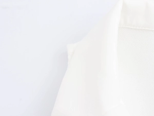 Close-up of white vest suit collar showing detailed woven fabric texture and stitching