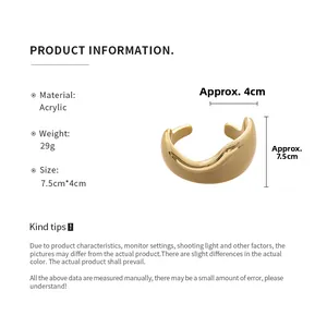 Detail of golden wave cuff bracelet in acrylic with size specs and 29g weight