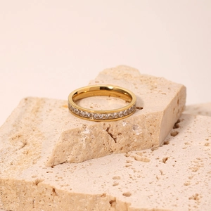 Minimalist gold titanium ring with clear cubic zirconia on a natural stone base