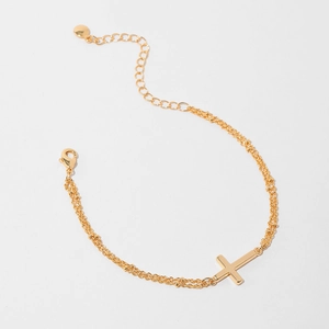 Detail of gold double-layered bracelet with cross pendant and adjustable lobster clasp