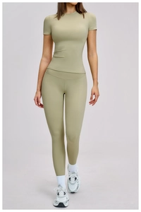 Detail of sage green compression yoga set with short sleeve top and high waist leggings