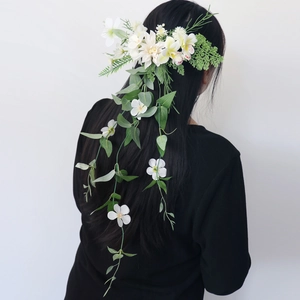 Elegant forest style bridal hairpiece with white simulated flowers and trailing greenery