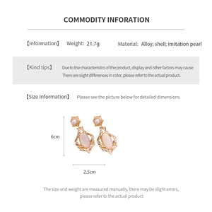 Detail showing vintage golden oval shell earrings dimensions and material specifications
