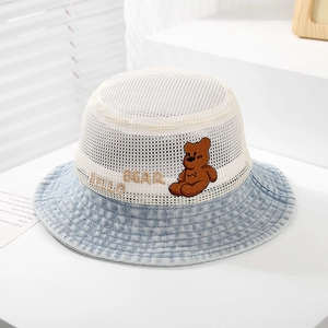 Detail of breathable mesh crown and cute bear embroidery on a denim bucket hat