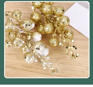 Macro shot of artificial golden Christmas berries with shimmering glitter and sequins