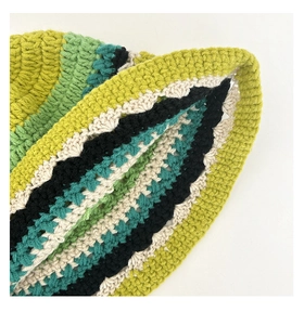 Close-up of handmade crochet bucket hat showing multi-color knit stitch textures