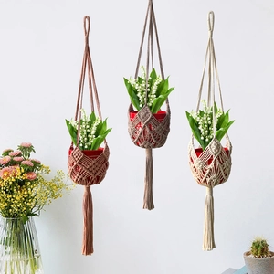 Three assorted macrame plant hangers in rose, brown, and off-white cotton with tassels