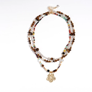 Three-layer bohemian tiger eye beaded necklace with a golden hammered flower pendant