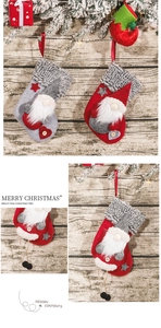 Detailed view of grey and red gnome Christmas stockings on a festive wooden background