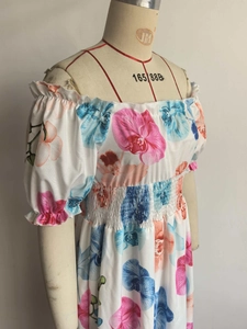 Détail d'une robe fleurie à épaules dénudées avec taille élastique et manches bouffantes