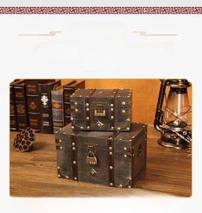 Close-up of vintage grey wooden storage boxes with metal rivets and antique locks