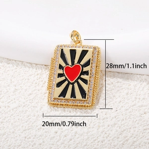 Detail view of a gold tarot-style pendant with red heart, zircon stones and 28x20mm dimensions