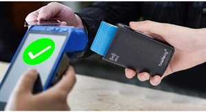 Manual operation of a black lychee-textured RFID wallet during a POS payment checkout