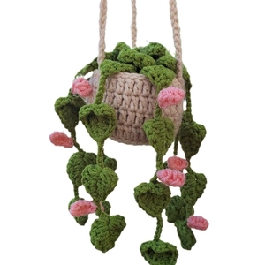 Handmade crochet hanging plant car charm with green leaves and pink flowers in beige pot