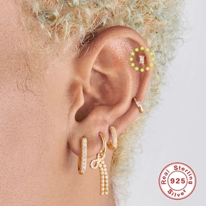 Close-up of gold S925 sterling silver earring set with zircon butterfly on model ear