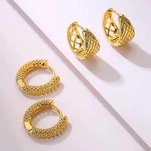 Retro gold-plated hoop earrings with textured bead and woven mesh patterns on white backdrop