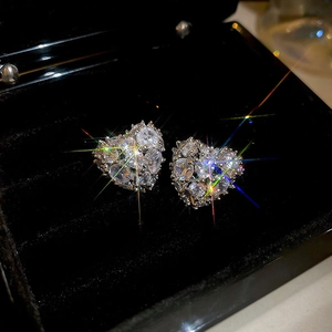 Macro shot of 18k gold plated heart stud earrings with cubic zirconia in a jewelry box