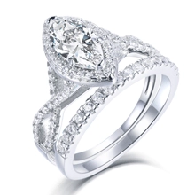 Macro detail of S925 silver halo ring set featuring marquise cut diamond and pavé band