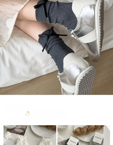 Detail of dark grey knit socks with black bow accents and premium cotton texture