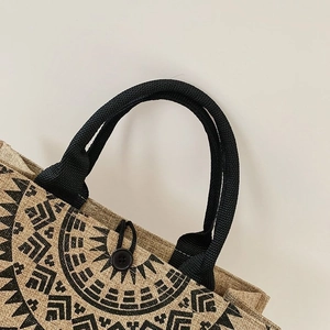 Detailed close-up of natural jute bag featuring mandala print and woven handle