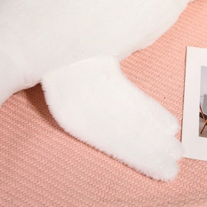 Close-up of the soft white plush fabric and high-quality stitching on the goose pillow