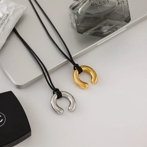 Minimalist 18K gold and silver horseshoe pendant necklaces with black wax ropes