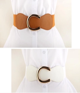 Detail showing elastic wide belts in brown and white with gold C-shape metal buckle