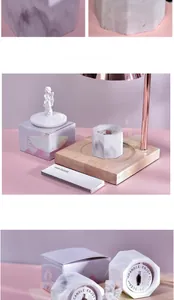 Macro view of marble-patterned soy candle in a hexagonal container with gift box