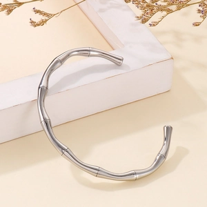 Artistic detail of silver bamboo joint open bangle with elegant natural textures