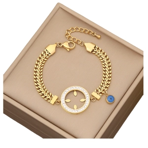 Gold-plated chunky chain bracelet with sparkling rhinestone circle and blue evil eye charm