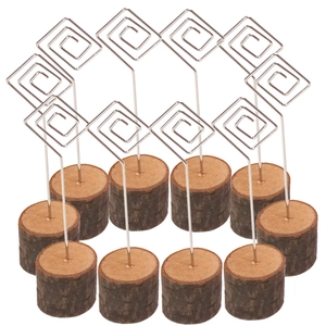 Close-up of 12 wooden place card holders with metal spiral clips on white background