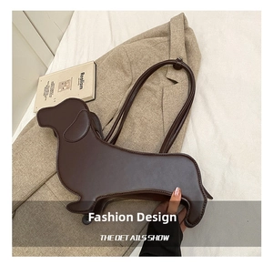 Detailed close-up of dark brown leather dachshund-shaped tote bag on stylish apparel