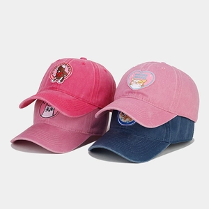 Detail of assorted vintage washed cotton baseball caps with cute cartoon embroidery