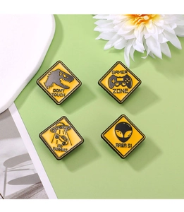 Set of four yellow diamond-shaped badges featuring dinosaur and gamer themes