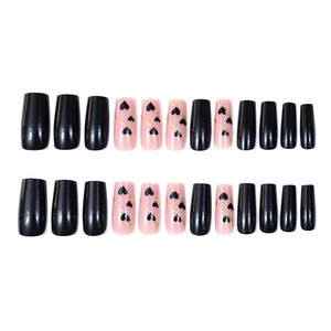 Coffin press-on nails with black and pink heart designs and gold glitter wavy lines