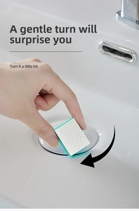 Detail of fish scale texture sponge cleaning a white ceramic bathroom sink surface
