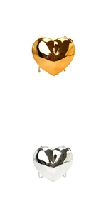 Detail of metallic heart-shaped clutch bags in gold and silver with mirror finish