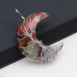 Macro detail of moon pendant with Tree of Life wire wrap and colorful resin stones