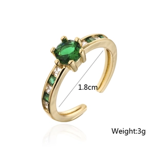 Detail of 18K gold ring showing 1.8cm diameter with green zircon stones