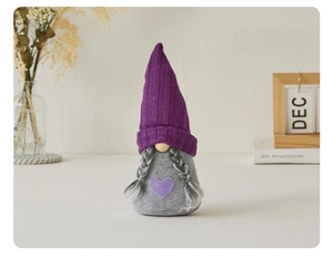 Detail of lavender purple knitted gnome doll with long braids and heart accent decoration