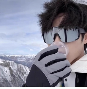 Outdoor sports sunglasses and winter ski gloves set against a snowy mountain backdrop