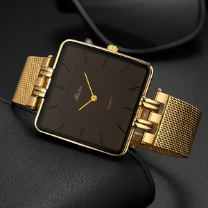 Detailed close-up of gold square watch with brown dial and Milanese mesh band