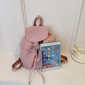 Pink nylon drawstring backpack for women with metal snap buckle and tablet size reference