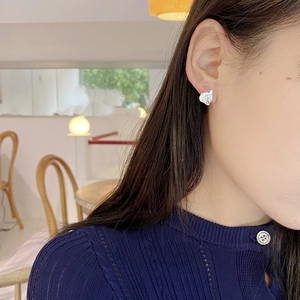 Macro shot of French retro S925 silver stud earrings with irregular geometric texture