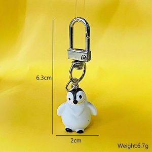 Cute 3D resin penguin keychain with size markings of 6.3cm height and 2cm width