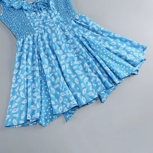Detailed view of sky blue floral dress with smocked bodice and delicate bow neckline