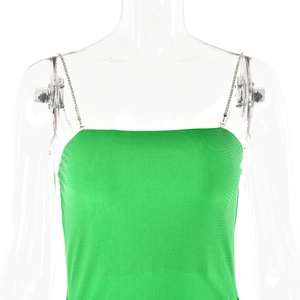 Detail of green satin dress featuring silver metal chain straps and a flat neckline