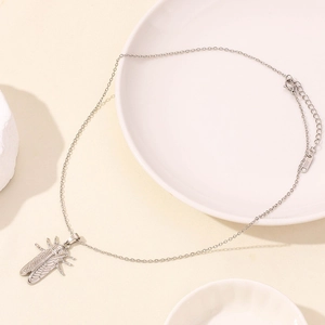 Macro detail of silver stainless steel cicada insect pendant with S.STEEL hallmark tag
