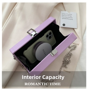 Detail of purple square bag interior capacity with chain strap and silver buckle